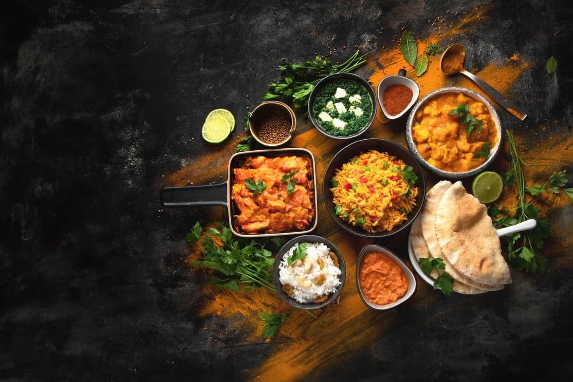 A colorful spread of Indian curries, rice, and bread