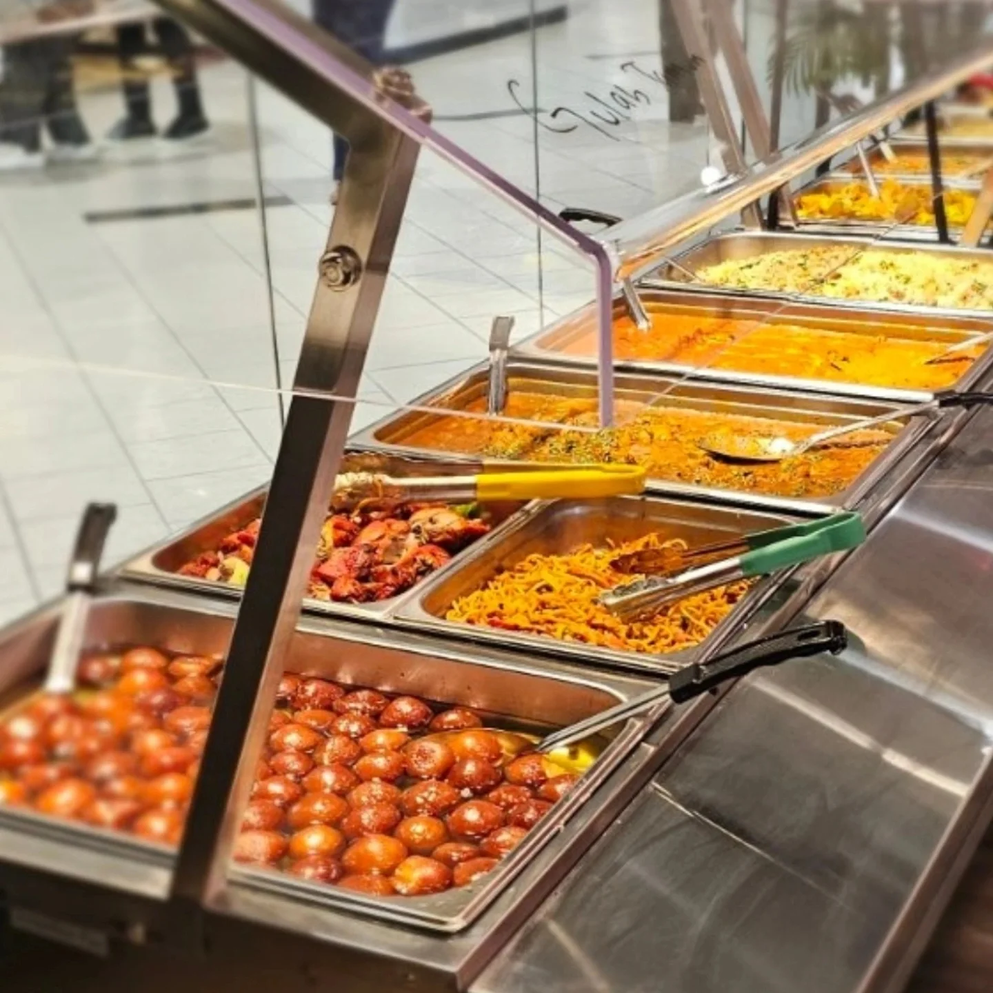 Krazy Curry Uptown buffet counter with trays of curries, rice, noodles and sweets